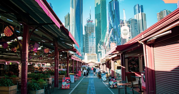 Thumbnail image of a bustling street leading into a modern cityscape, potentially representing urban migration services offered by Visa Envoy.