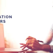 An image of a woman sitting at a desk, working on a computer, with the text "IMMIGRATION WEBINARS" in bold to her left, suggesting a promotional banner for educational webinars about immigration.