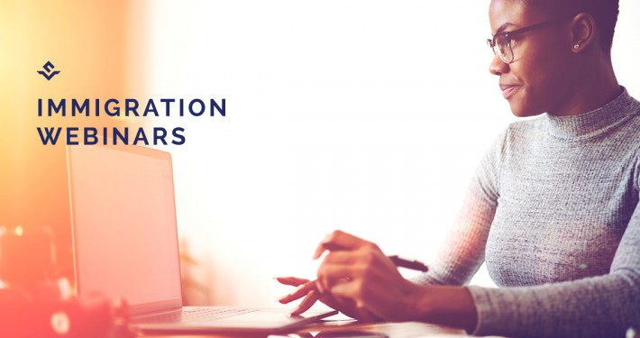An image of a woman sitting at a desk, working on a computer, with the text "IMMIGRATION WEBINARS" in bold to her left, suggesting a promotional banner for educational webinars about immigration.