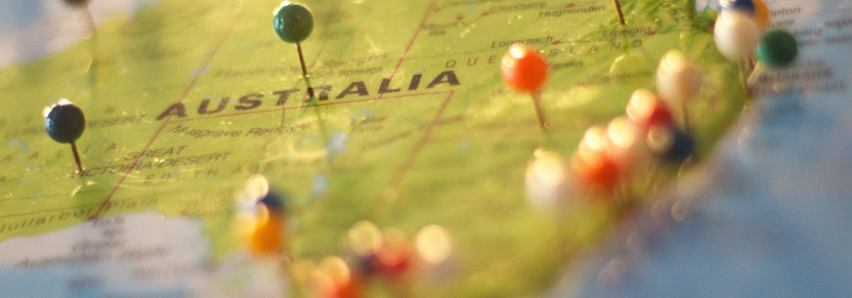 A close-up shot of pins in a physical map of Australia