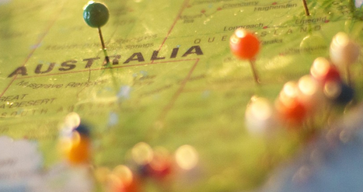 A close-up shot of pins in a physical map of Australia