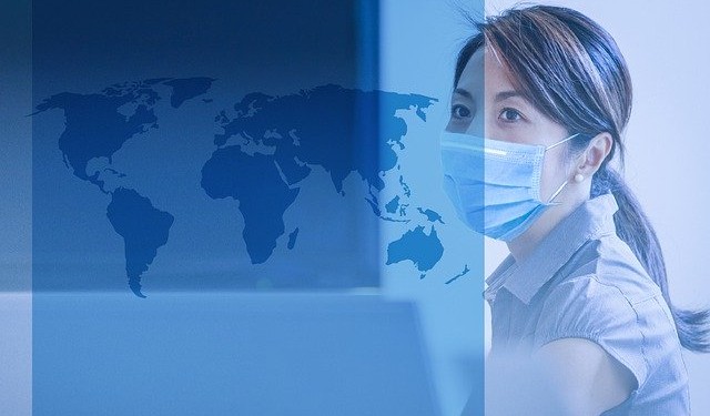 Graphic image depicting a female figure in a business suit with a digital blue overlay, in profile looking to the right. Behind her is a stylized representation of a world map in various shades of blue, symbolizing global connectivity or international business. The design is likely related to themes of global cooperation or international workforces, possibly in the context of critical sectors during the coronavirus pandemic, as suggested by the filename