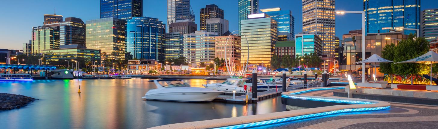 Boats at a marina against a backdrop of office blocks in downtown Perth, Western Australia