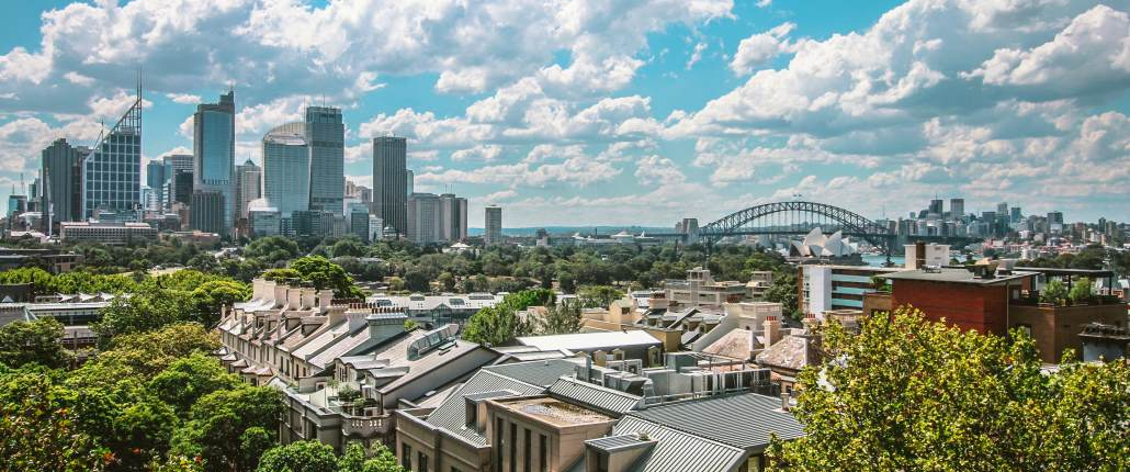 A view over a suburb of Sydney, Australia, with downtown Sydney, Sydney Opera House and Sydney Harbour Bridge in the background