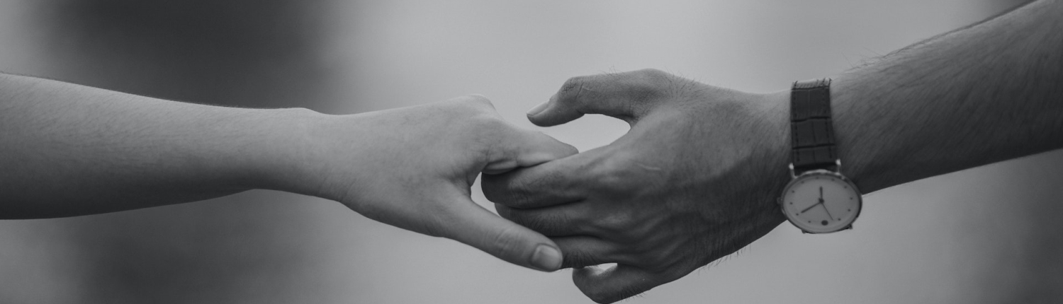 A close up of two hands holding one another